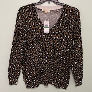 Brand new Michael Kors animal print sweater size L 2 inch slit up each side
